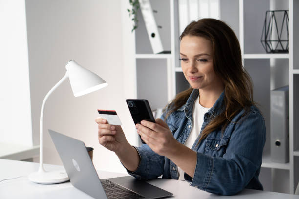 istock A young professional is actively engaged in online shopping, utilizing a credit card and a smartphone to make purchases, showcasing a convenient modern lifestyle where technology meets commerce 2191750871