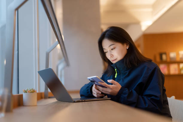 istock asian female working on laptop in office beside window 2191751791