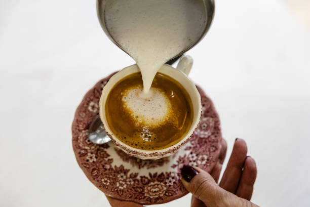 istock Milk being poured into espresso to create a latte art heart 2191754264