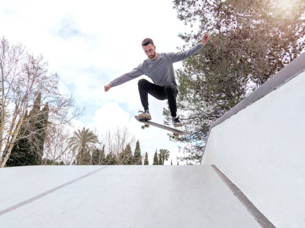 istock Skateboarder Performing a Trick in a Skate Park 2191758631