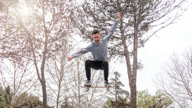 istock Skateboarder Performing a Jump Trick in a Park 2191758634