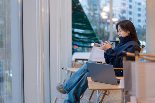 istock asian female using smart phone in office 2191758993