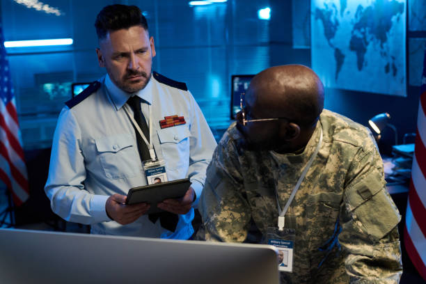 istock Officer in uniform looking at colleague 2191760281