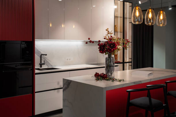 istock Modern red kitchen with marble island, white cabinets and kitchen appliances 2191763094