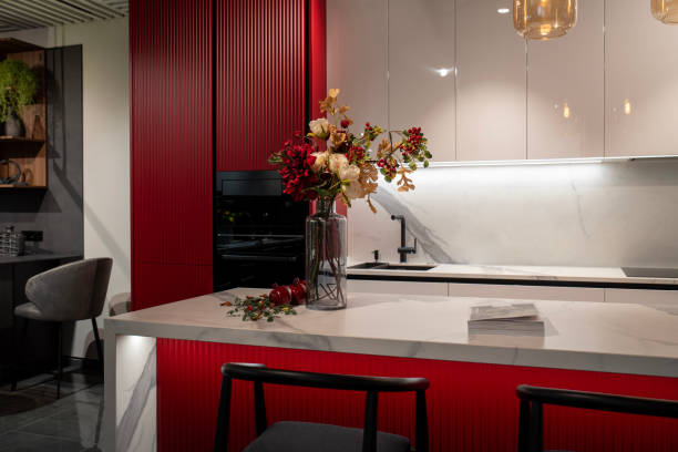Modern red kitchen with marble island and kitchen appliances