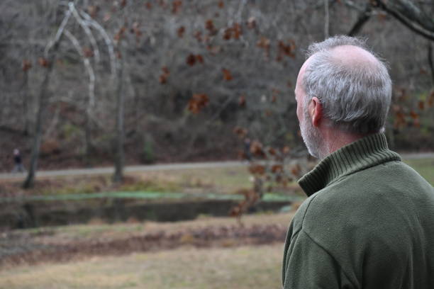 Man with gray hair looking at nature