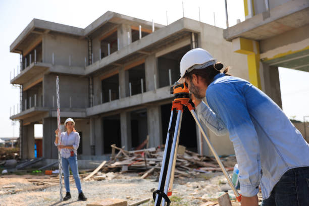 Surveyors adjusting focus with their total station