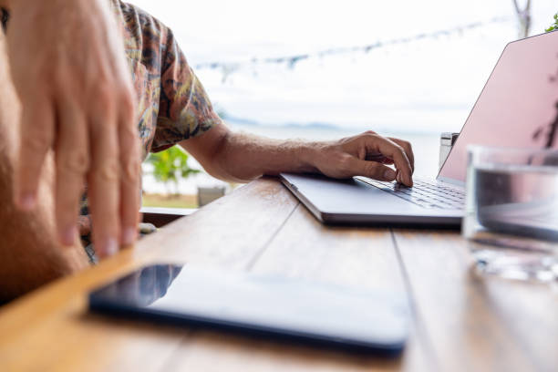 istock Person Working on Laptop Outdoors at Wooden Table 2191770025