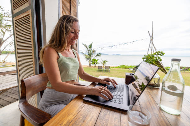 istock Woman Working Remotely with Ocean View 2191770050