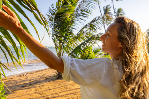 istock Woman Enjoying a Tropical Beach Under Palm Trees 2191770267