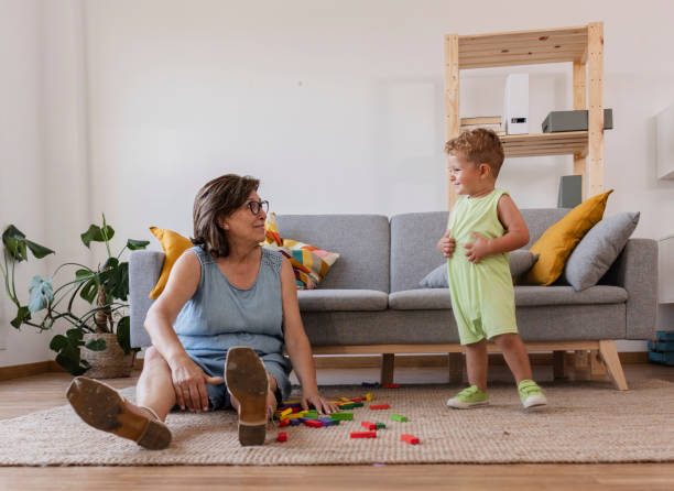 istock Grandmother playing with grandson at home, building blocks fun 2191774835