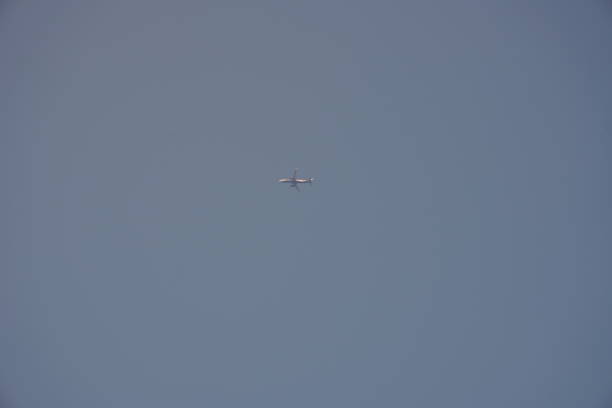 An airplane is flying in the sky, passenger airplane