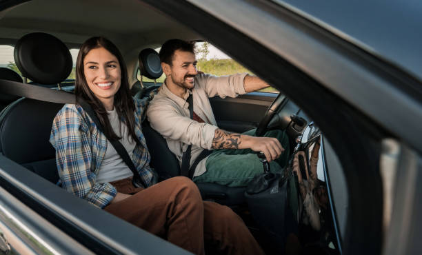istock Happy young couple enjoying a car road trip adventure 2191782102