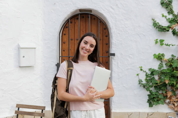 istock Happy remote worker carrying a laptop and backpack, embracing work-life balance while enjoying the great outdoors and nature's beauty 2191783653