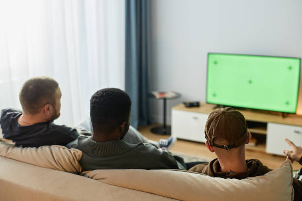 istock Back View Men Watching TV with Green Screen Sitting on Sofa 2191783816