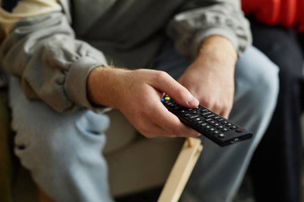 istock Close Up of Hand Holding TV Remote 2191783824
