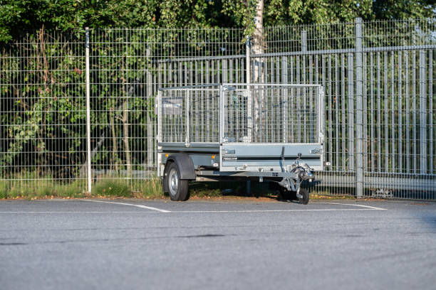 istock Small cage trailer parked by a fence.. 2191783990
