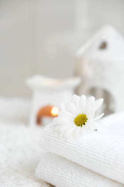 istock White towels with chamomile flower and aroma lamp 2191788249