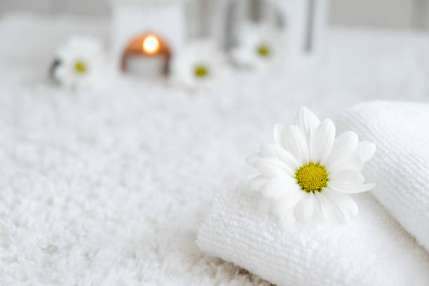 istock White towels with chamomile flower and aroma lamp 2191788250
