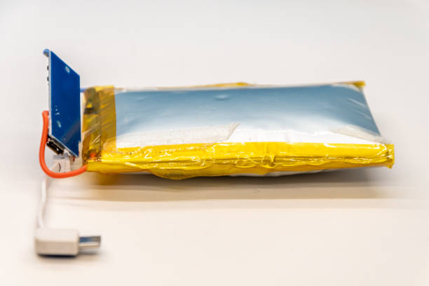 Bloated lithium-ion battery with USB connector on white background.