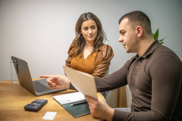 istock Young couple comparing account balances online with their bills and making a saving plan at home. 2191791767