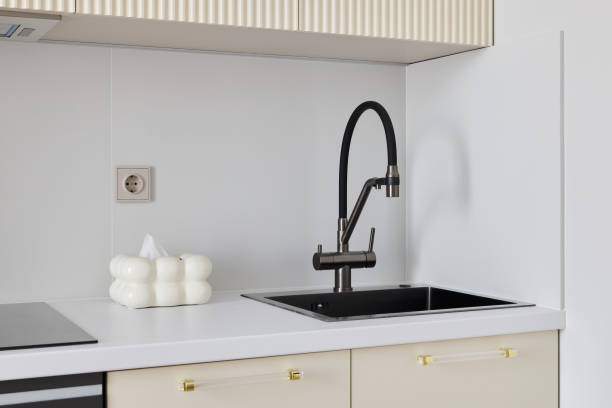 An Elegant Modern Kitchen Featuring a Black Faucet and a Sleek Contemporary Design