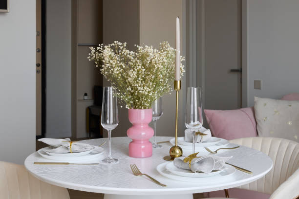 istock An Elegant Dining Setup Featuring a Delightful Pink Vase Accompanied by White Flowers 2191792204