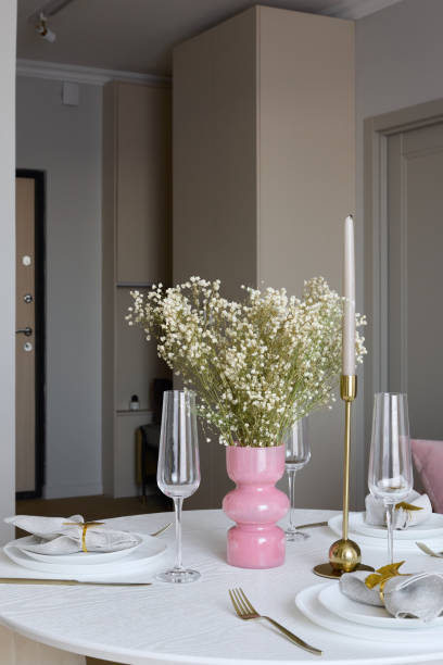 istock An Elegant Dining Table Setup Featuring a Beautiful Pink Vase Filled with Fresh Flowers 2191792210