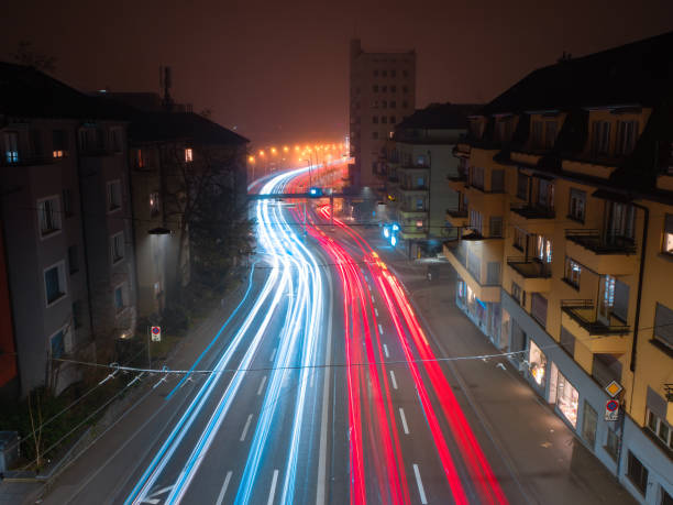 Wave motion speed red and blue lighting background, the movement of the lights with curve through the Zurich streets