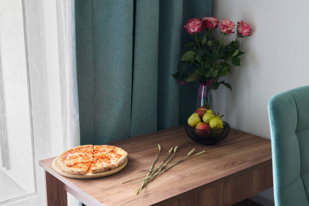 istock A cozy dining table setting adorned with delicious pizza alongside fresh beautiful flowers 2191792992