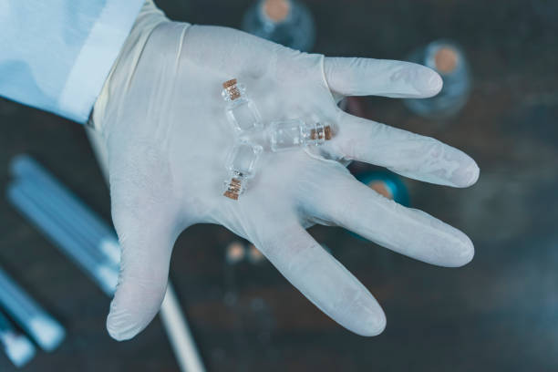 istock Scientist holding small vials in a gloved hand 2191793844