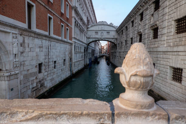 Venice, Italy - December 11, 2024: Gondolas sailing under the Ponte de Canonica, viewed from the Ponte della Paglia, in Venice, Italy.