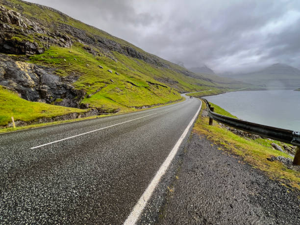 istock Curved Coastal Road Runs Between the Mountains and the Sea 2191795371