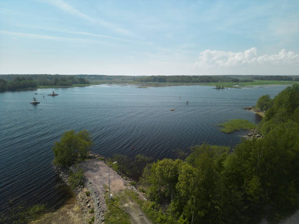 istock A Serene and Picturesque Lake View Surrounded by Lush Greenery Beneath a Bright Blue Sky 2191795712