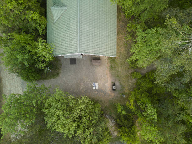 istock A beautiful aerial view showcases a charming house that is completely surrounded by lush greenery 2191796110