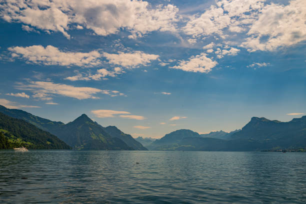 Mountain in the in summer, panoramic view with mountain. Alps mountains. Alpine mountain scenery. Mountain with lake in Alps. Mountains over the lake and the alps