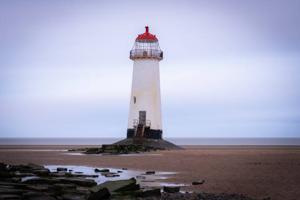 istock Point of Ayr lighthouse standing on welsh beach during cloudy day 2191797630
