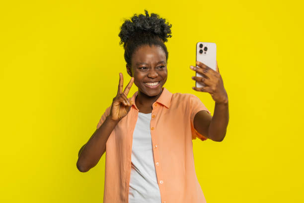 istock African American woman smiling with smartphone, taking selfie, joyful expression, confident pose 2191799050
