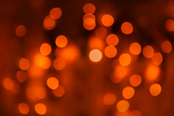 istock Orange lights abstract background. Blurred glowing lights with bokeh 2191799560