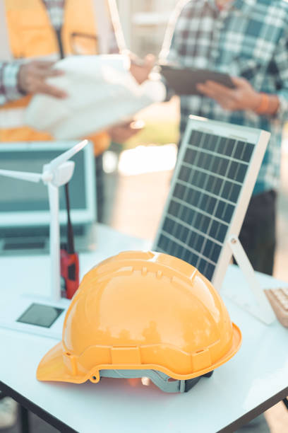 istock Construction concept: Engineer's hands drawing plans on blue print with architect equipment discussing floor plans over architectural plans, blueprints at table in office. Close-up vertical image 2191802042