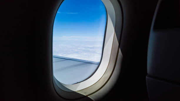 istock Airplane window with a view of the sky 2191803809