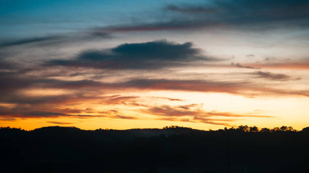 istock Majestic sunset sky showcasing a gradient of warm hues with textured clouds adding depth and beauty. 2191805441