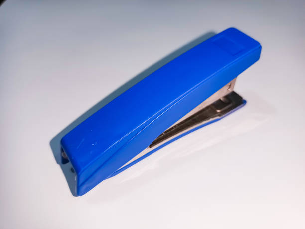 The minimalist composition emphasizes the stapler as the focal point.