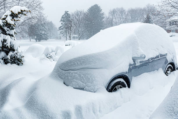 Car Buried Under Deep Blizzard Storm Snow stock photo