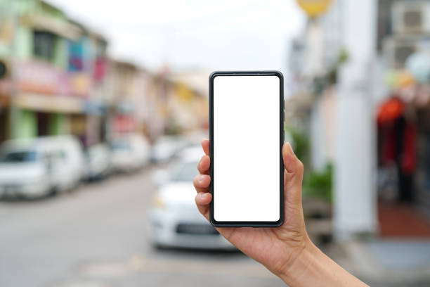 istock Hand Holding Smartphone with Blank Screen on a Street 2191814679
