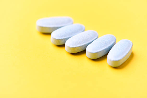 istock Multivitamin tablets on bright paper background. Close up. Copy space. 2191815276