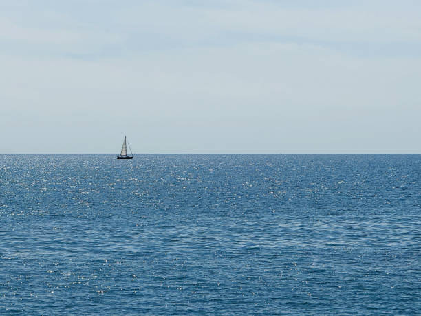 Ocean blue shiny water and clear sunny sky horizon