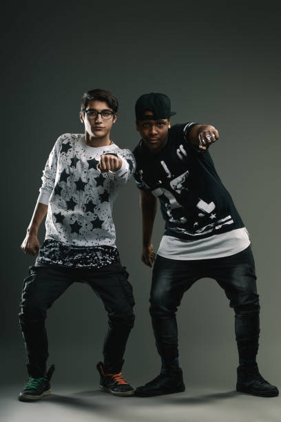 istock Two young men pointing fingers towards camera in studio 2191816410