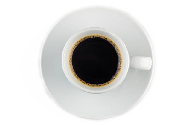Enjoying the aroma of freshly brewed coffee in a simple white cup, perfect for a peaceful morning experience.