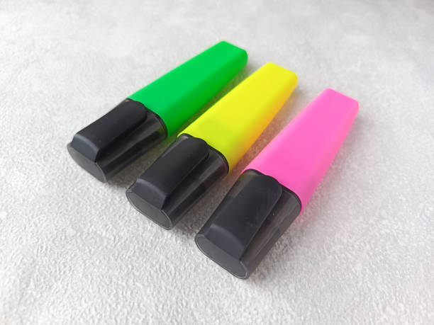 istock A green, yellow and pink marker is on the table. Multi-colored markers for making a list. Children's markers for drawing. 2191819556